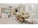 Open concept dining area with an oval table and chairs, adjacent to living room and kitchen at 6249 Mesa Gln, Bradenton, FL 34203