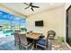 Covered patio with dining area, pool view, and modern furniture at 6249 Mesa Gln, Bradenton, FL 34203