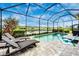 Relaxing screened pool and patio area with lounge chairs and lake view at 6249 Mesa Gln, Bradenton, FL 34203