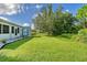 Spacious backyard with lush lawn, shed, and mature trees at 6643 Lapidus Rd, North Port, FL 34291