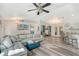 Bright living room with light grey sectional sofa, wood-look floors, and access to kitchen at 6643 Lapidus Rd, North Port, FL 34291