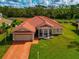 One-story home with terracotta roof, two-car garage, and well-manicured lawn at 7115 39Th E Ln, Sarasota, FL 34243