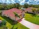 One-story house with terracotta roof and two-car garage, side view at 7115 39Th E Ln, Sarasota, FL 34243