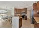 An open-concept kitchen that features stainless steel appliances and granite countertops at 7115 39Th E Ln, Sarasota, FL 34243