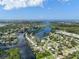 Wide aerial showcasing waterfront community and waterways at 741 Shakett Creek Dr, Nokomis, FL 34275