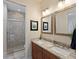 Bathroom with double vanity, granite countertop, and a walk-in shower at 741 Shakett Creek Dr, Nokomis, FL 34275