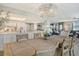 Bright dining area with large table and chairs, offering an open view to the living room and kitchen at 8779 Midnight Pass Rd # 206H, Sarasota, FL 34242