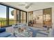 Bright lanai with outdoor furniture and water views at 8779 Midnight Pass Rd # 206H, Sarasota, FL 34242