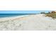 Stunning beachfront view with white sand and ocean waves at 8779 Midnight Pass Rd # 206H, Sarasota, FL 34242