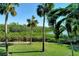 Waterfront view with lush landscaping and palm trees at 8779 Midnight Pass Rd # 206H, Sarasota, FL 34242