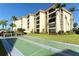 Building exterior with landscaping and shuffleboard at 8779 Midnight Pass Rd # 206H, Sarasota, FL 34242
