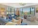 Cozy living room featuring comfortable seating and large windows at 8779 Midnight Pass Rd # 206H, Sarasota, FL 34242