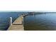 Long wooden dock stretching over the water towards a boat lift at 8779 Midnight Pass Rd # 206H, Sarasota, FL 34242