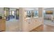 Open concept kitchen with white cabinets and breakfast bar at 8779 Midnight Pass Rd # 206H, Sarasota, FL 34242