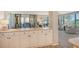 White kitchen cabinets and countertops with access to living room at 8779 Midnight Pass Rd # 206H, Sarasota, FL 34242