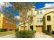 Three-story townhome with tan siding and a two-car garage at 9016 White Sage Loop, Lakewood Ranch, FL 34202