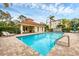 Community pool with lounge chairs and patio at 980 Cooper St # 302, Venice, FL 34285