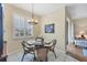 Cozy breakfast nook with glass table and wicker chairs at 980 Cooper St # 302, Venice, FL 34285