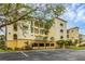 Condo building with parking and landscaping at 980 Cooper St # 302, Venice, FL 34285