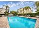 Community pool with lounge chairs and patio at 980 Cooper St # 302, Venice, FL 34285