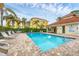 Community pool with lounge chairs and patio at 980 Cooper St # 302, Venice, FL 34285