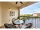 Private balcony with outdoor seating and lake view at 980 Cooper St # 302, Venice, FL 34285