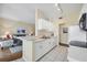 Open kitchen with breakfast bar and view of living room at 980 Cooper St # 302, Venice, FL 34285