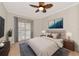 Bedroom with a bed, ceiling fan, and sliding door leading to the pool at 10550 Old Grove Cir, Bradenton, FL 34212