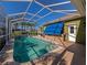 Screened pool and spa with covered patio and outdoor bar at 10550 Old Grove Cir, Bradenton, FL 34212