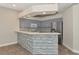 Modern kitchen with gray cabinets, quartz countertops, and stainless steel appliances at 10550 Old Grove Cir, Bradenton, FL 34212