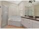 Elegant bathroom with double sinks, corner tub, and separate shower at 10550 Old Grove Cir, Bradenton, FL 34212