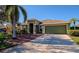 Green house with palm tree and driveway at 10550 Old Grove Cir, Bradenton, FL 34212