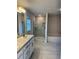 Bathroom with a walk-in shower, soaking tub, double vanity, and modern fixtures at 1157 Duquesne Rd., Venice, FL 34293
