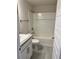 Bright bathroom featuring a shower-tub combo, white tile surround, and stylish vanity with gray countertops at 1157 Duquesne Rd., Venice, FL 34293