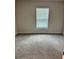 Bedroom featuring a large window, neutral walls, carpet flooring, and ample natural light at 1157 Duquesne Rd., Venice, FL 34293