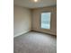 Cozy bedroom with neutral walls, carpet flooring, and natural light from the window at 1157 Duquesne Rd., Venice, FL 34293