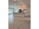 Open-concept living space with a stylish kitchen featuring an island with modern appliances and bright white cabinets at 1157 Duquesne Rd., Venice, FL 34293