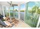 Bright sunroom boasts water views and comfy seating at 1350 N Portofino Dr # 302Tar, Sarasota, FL 34242