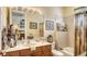 Bright bathroom with a shower/tub combo and wood vanity at 1602 3Rd Street E Cir, Palmetto, FL 34221