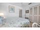 Bedroom with a bed, double doors, and white built-ins at 1624 Stickney Point Rd # 401, Sarasota, FL 34231