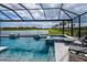 Beautiful screened-in pool and spa with comfortable lounge seating and scenic lake views at 16606 Barnwood Pl, Bradenton, FL 34211