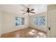 Bright bedroom with hardwood floors, ceiling fan, and natural light from the windows at 1920 Laurel St, Sarasota, FL 34236