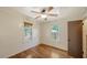 Well-lit bedroom with hardwood floors, ceiling fan, and natural light from the windows at 1920 Laurel St, Sarasota, FL 34236