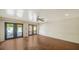 Spacious room with hardwood floors, ceiling fan, and double doors leading to the outside at 1920 Laurel St, Sarasota, FL 34236