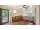 Bonus room featuring hardwood floors, a ceiling fan, and custom-built shelving at 1920 Laurel St, Sarasota, FL 34236