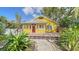 Yellow cottage with a front porch and landscaped walkway at 1920 Laurel St, Sarasota, FL 34236