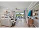 Bright living room with comfy seating, large TV, and sliding doors leading to a patio at 2520 Avolet Ct, Bradenton, FL 34211