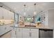 Island kitchen with granite countertops, white cabinets, and stainless steel appliances at 2520 Avolet Ct, Bradenton, FL 34211