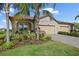 Beautiful house exterior with three-car garage, stone accents, and lush landscaping at 2520 Avolet Ct, Bradenton, FL 34211