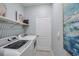 Convenient laundry room with washer, dryer, and shelving at 2520 Avolet Ct, Bradenton, FL 34211